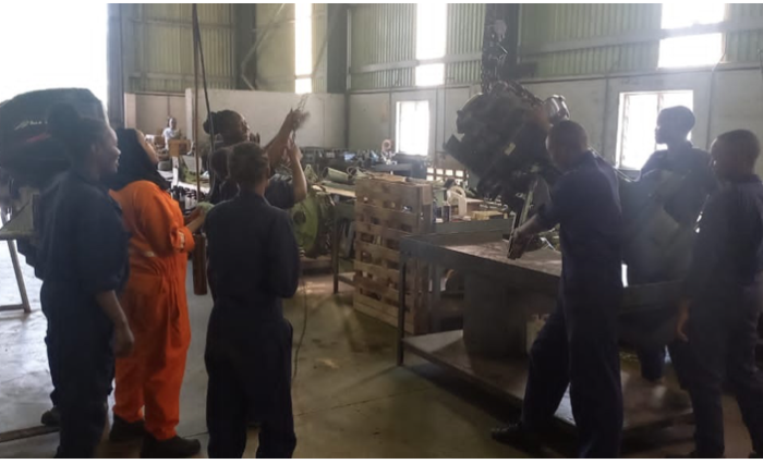 KCNP Marine students on attachment working on a ship outboard engine AT Kenya Navy